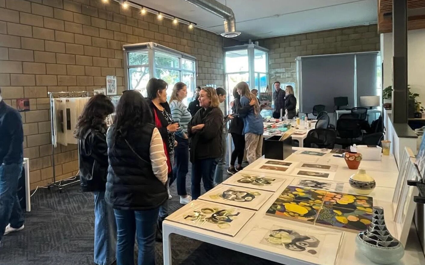 Guests browsing artwork at a community event at Ivy Street